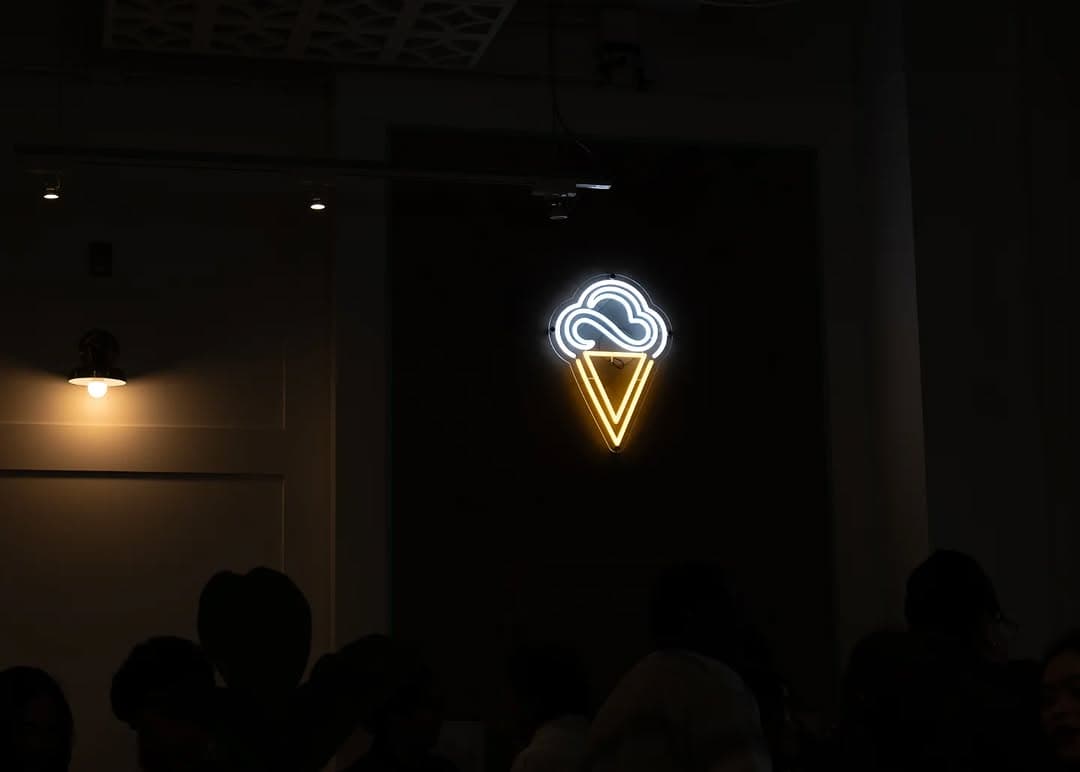 The Parlour neon sign glowing in the dark shop window