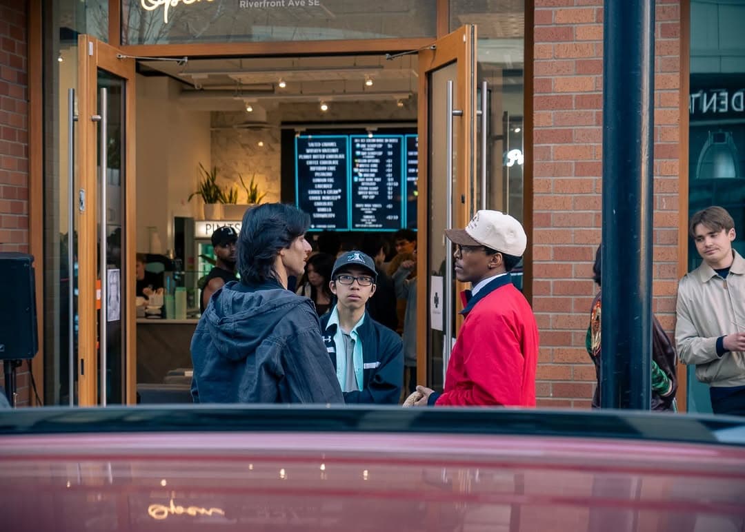 Guests gathered outside the brick storefront during the social